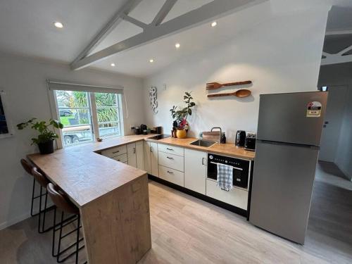 a kitchen with a refrigerator and a counter top at Studio on Oakview in Newstead