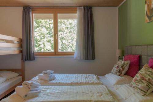 a bedroom with a bed with towels on it at Residenz Wildkogelbahnen Top 12 in Neukirchen am Großvenediger