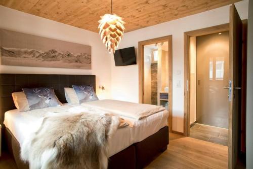 a bedroom with a large bed with a large dog sitting on it at Residenz Wildkogelbahnen Top 17 in Neukirchen am Großvenediger