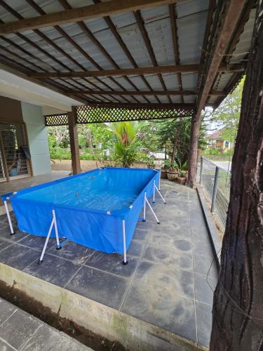 a blue ping pong table on a patio at forest villa in Seri Kembangan