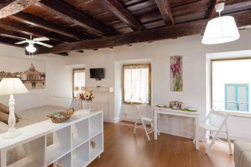 a large living room with white furniture and windows at House&Colosseum in Rome