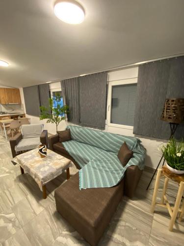 a living room with a couch and a table at Four Seasons in Leptokaria