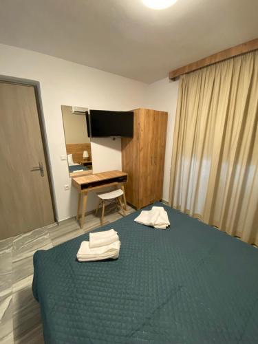 a bedroom with a bed with two towels on it at Four Seasons in Leptokaria