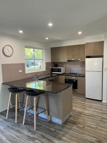an empty kitchen with a counter and a refrigerator at River Frontage Unit Moama in Moama