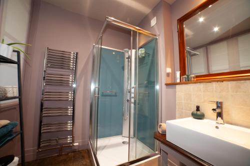 a bathroom with a shower and a sink at Pont Vieux Chambres et Gites in Confolens
