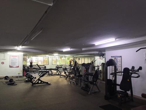 a gym with a bunch of treadmills and machines at Venice Hill Cheras Young Forever Homestay in Cheras