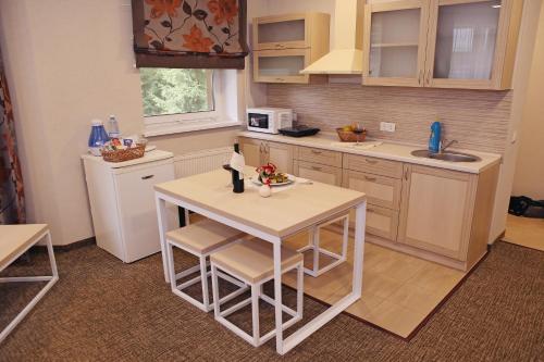 a kitchen with a small table and a microwave at Voevodyno Resort in Tur'ya Pasika