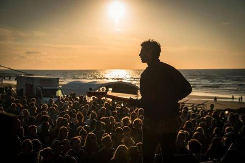 a man standing in front of a crowd at the beach at Port-Guillaume, résidence de vacances avec mer & piscine in Dives-sur-Mer
