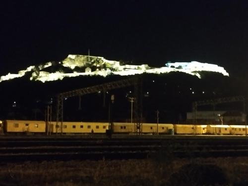 a train station at night with a snow covered mountain at Jasna1 in Knin