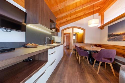 a kitchen with a table and a dining room at Haus Wildkarblick Top 6 in Nothdorf