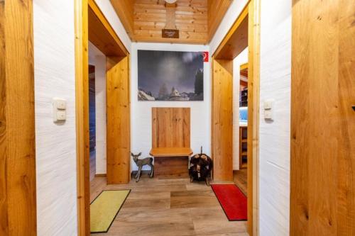 a hallway with wood paneling and a large painting on the wall at Haus Wildkarblick Top 6 in Nothdorf