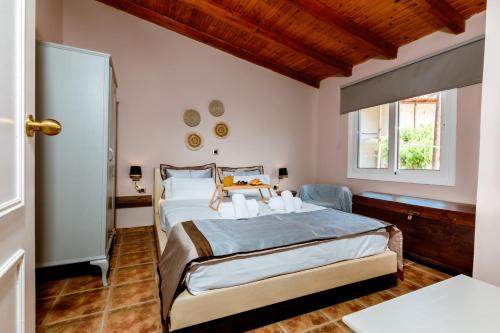 a bedroom with a large bed and a window at Anna's Village House in Perivólia