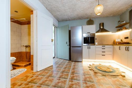 a kitchen with a sink and a refrigerator at Anna's Village House in Perivólia