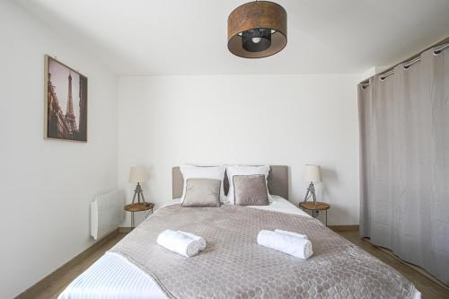 a bedroom with a bed with two pillows on it at Quijote, Maison moderne avec terrasse à Caen in Caen