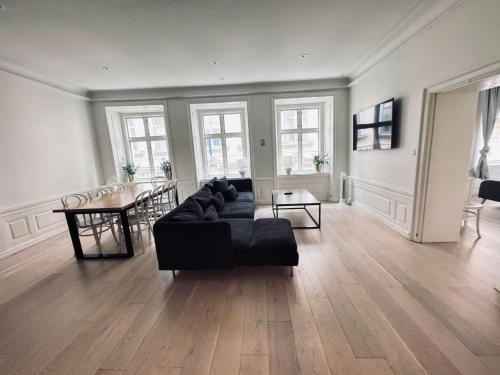 a living room with a black couch and a table at The Place to be in Stockholm Old Town in Stockholm