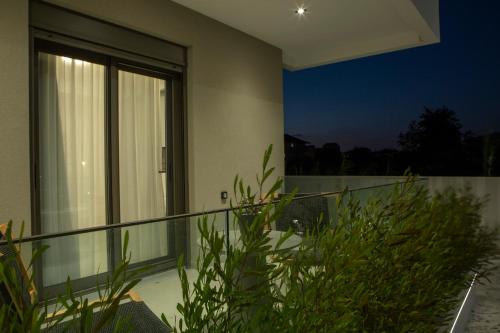 a house with a balcony at night at Achillion Suites in Lefkada Town