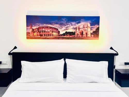 a bedroom with a bed with a painting above it at Licheni R-home in Rome