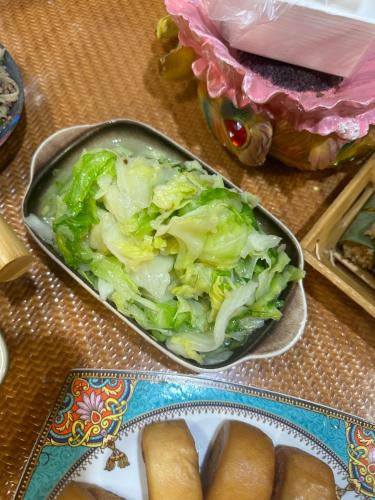 a table with a tray of lettuce and a plate of food at Đại Dương Xanh 502TDH204 in Hanoi