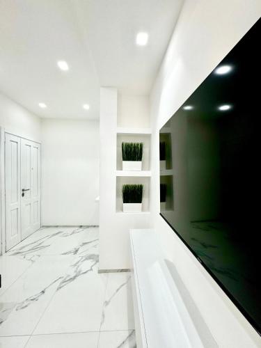 a living room with white walls and marble floors at Licheni R-home in Rome