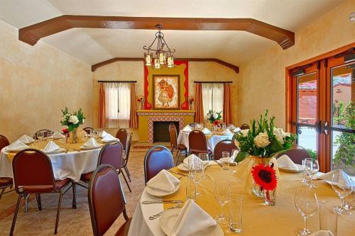 a conference room with tables and chairs and a chandelier at Los Arboles Hotel in Palm Springs