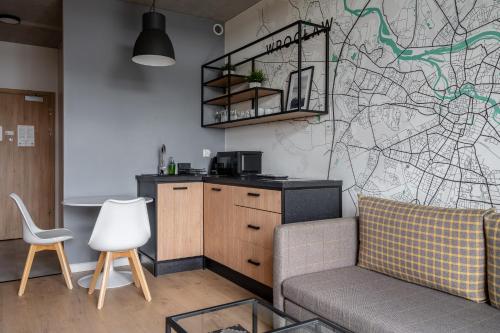 a living room with a couch and a map on the wall at RentPlanet - Apartamenty Zarembowicza in Wrocław