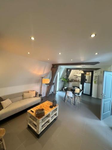 un salon avec un canapé et une table dans l'établissement Charmant appartement troyen, à Troyes