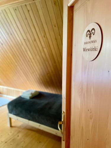 a door to a room with a bed in it at Baranówka in Kamesznica