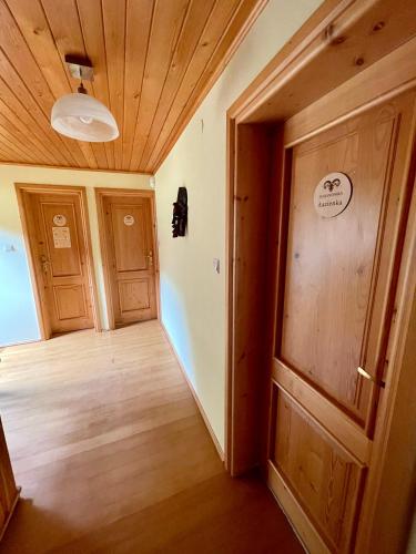 an empty hallway with wooden floors and doors at Baranówka in Kamesznica