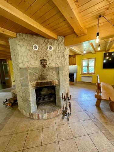a living room with a stone fireplace in a house at Baranówka in Kamesznica