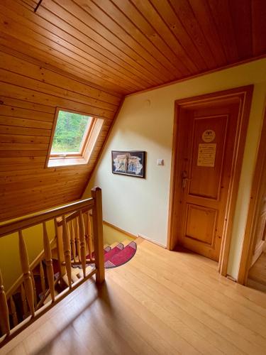 an attic room with a staircase and a window at Baranówka in Kamesznica