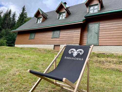 a chair sitting in front of a house at Baranówka in Kamesznica