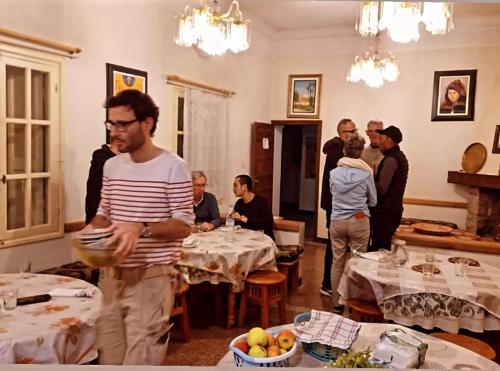 a group of people standing in a room with tables at Midalt in Midelt