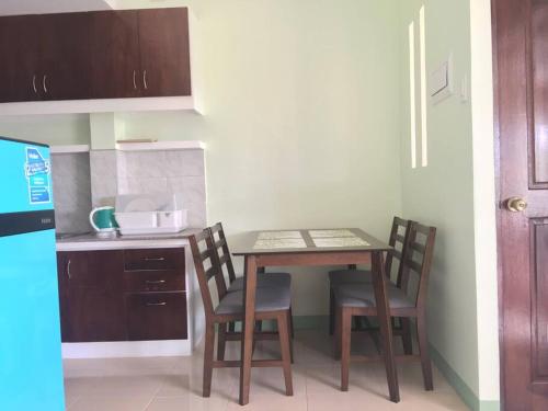 a small kitchen with a table and two chairs at Ocean View Apartment-Near Blood Compact Shrine in Tagbilaran City