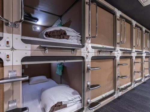 an interior view of an rv with a bed in it at Tabist Takamatsu Pearl Hotel in Takamatsu