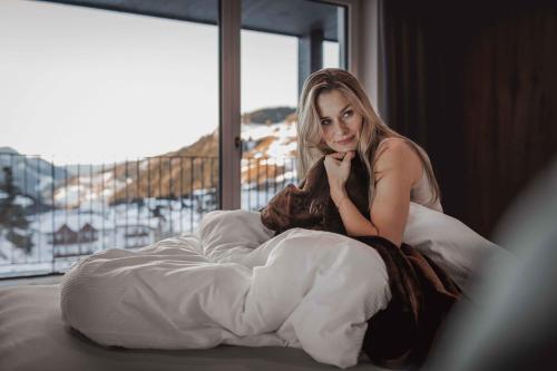 Ένα ή περισσότερα κρεβάτια σε δωμάτιο στο Hotel Continental Dolomites