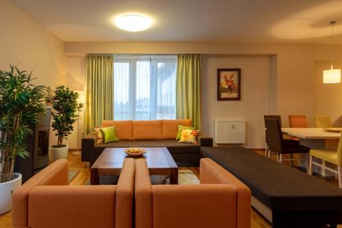 a living room with a couch and a table at Súkromné apartmány v Crocuse s výhľadom na hory in Štrbské Pleso
