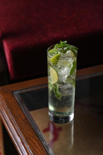 a glass of water with lime and mint on a table at Umed Bhawan Palace, Kotah in Kota