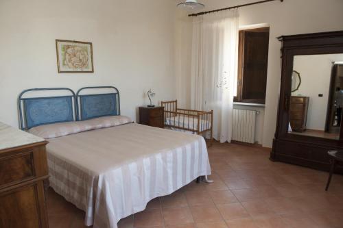 a bedroom with a bed and a dresser and a mirror at Casa Lippi in Casal Velino