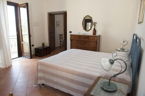 a bedroom with a bed and a dresser and a mirror at Casa Lippi in Casal Velino