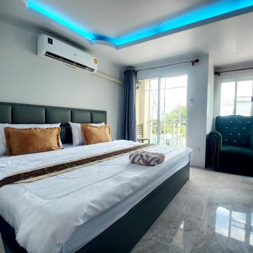 a bedroom with a large bed with a blue light at SUKANO Apartment VIP in Ban Khlong Chao