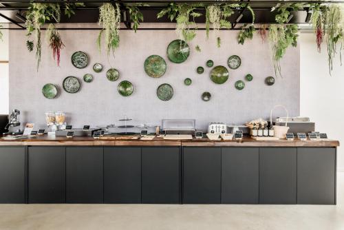 a counter with green plates hanging on a wall at Relais Chiaramonte in Ragusa