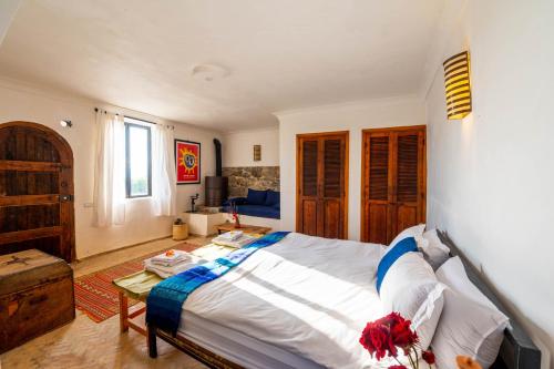 a bedroom with a large bed and a table at Farm Finn in Chefchaouene