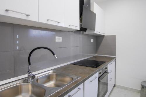 a kitchen with a sink and a faucet at Lemon tree in Podaca