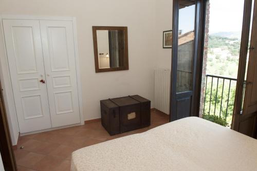a bedroom with a bed and a mirror on the wall at Casa Lippi in Casal Velino