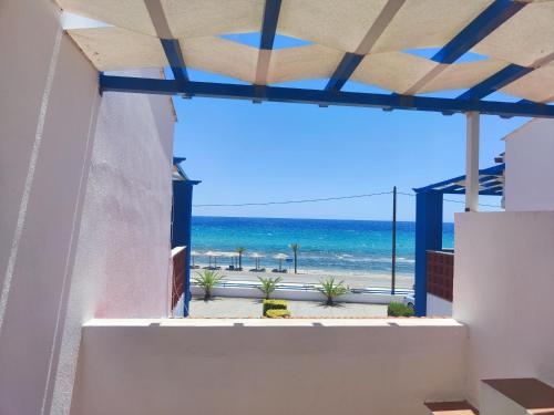 a view of the beach from the balcony of a house at Seaside house in Sozopoli