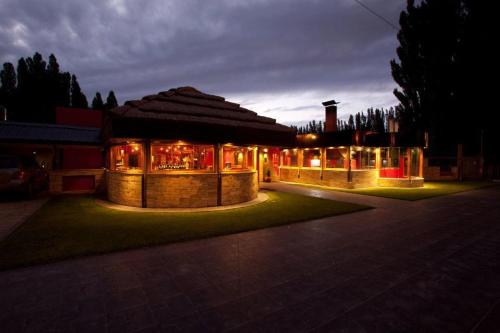 a building with a restaurant with lights at night at Hotel " Rio Grande " in Malargüe