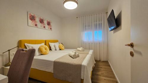 En eller flere senge i et værelse på Apartment Leilani & Karolina