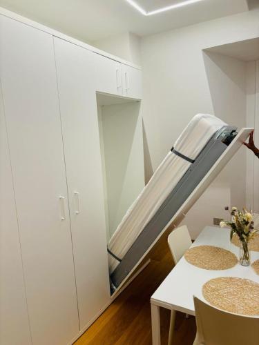 a staircase in a room with a table and chairs at La Mombellina OLTRE HOME HOLIDAYS in Sanremo