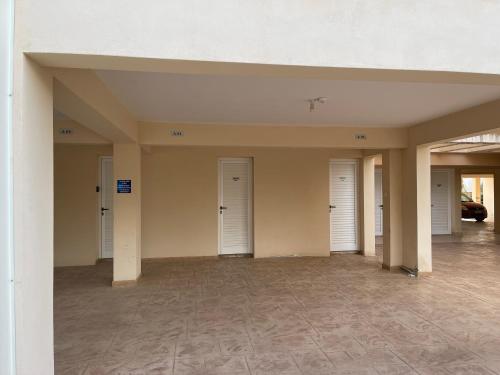 a empty room with three doors in a building at Nissi Beach beautiful apartment in Ayia Napa