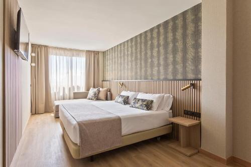 a bedroom with a large bed in a room at Acta Pirámides in Madrid